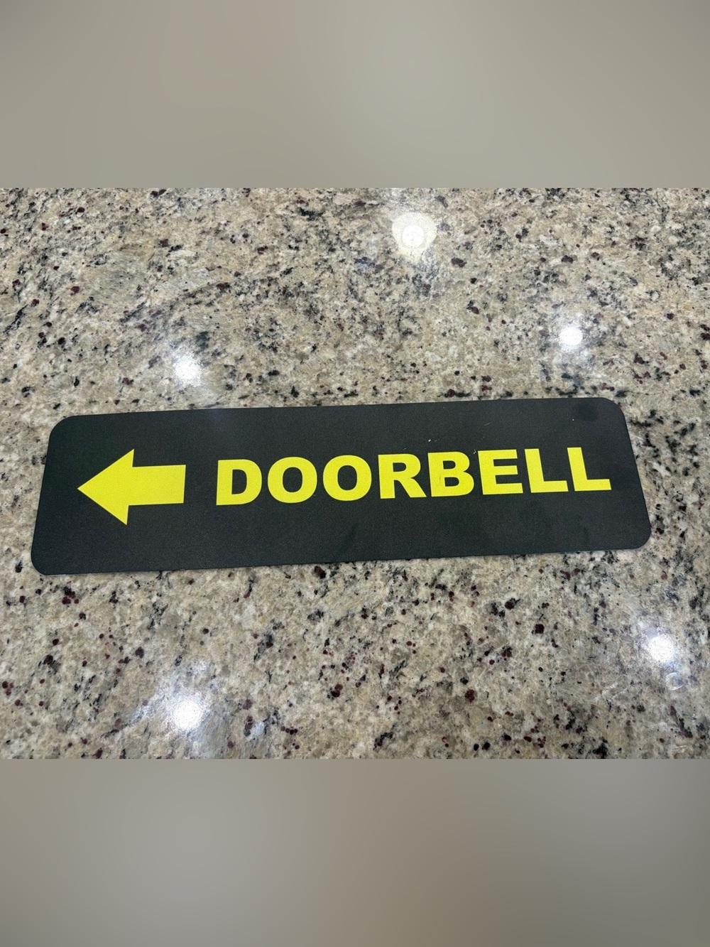 Doorbell with arrow sign in black and yellow A few tiny scratches